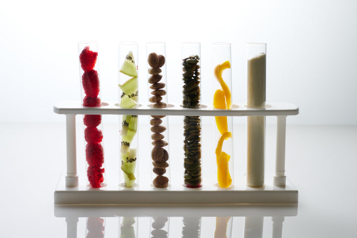 Photo of science beakers filled with organic ingredients. Sulinu uses clinically tested patented ingredients backed by results in its post surgery supplements designed to support wound healing after cosmetic surgery.