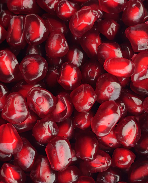 A detail photo of pomegranate arils. Before + After Vitals pre surgery supplements contain essential vitamins that promote tissue repair, reduce inflammation, and boost the immune system.