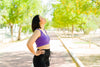 A woman takes a deep breath out on a walk. How long do breast reconstruction scars take to heal? Read our complete guide to learn more.