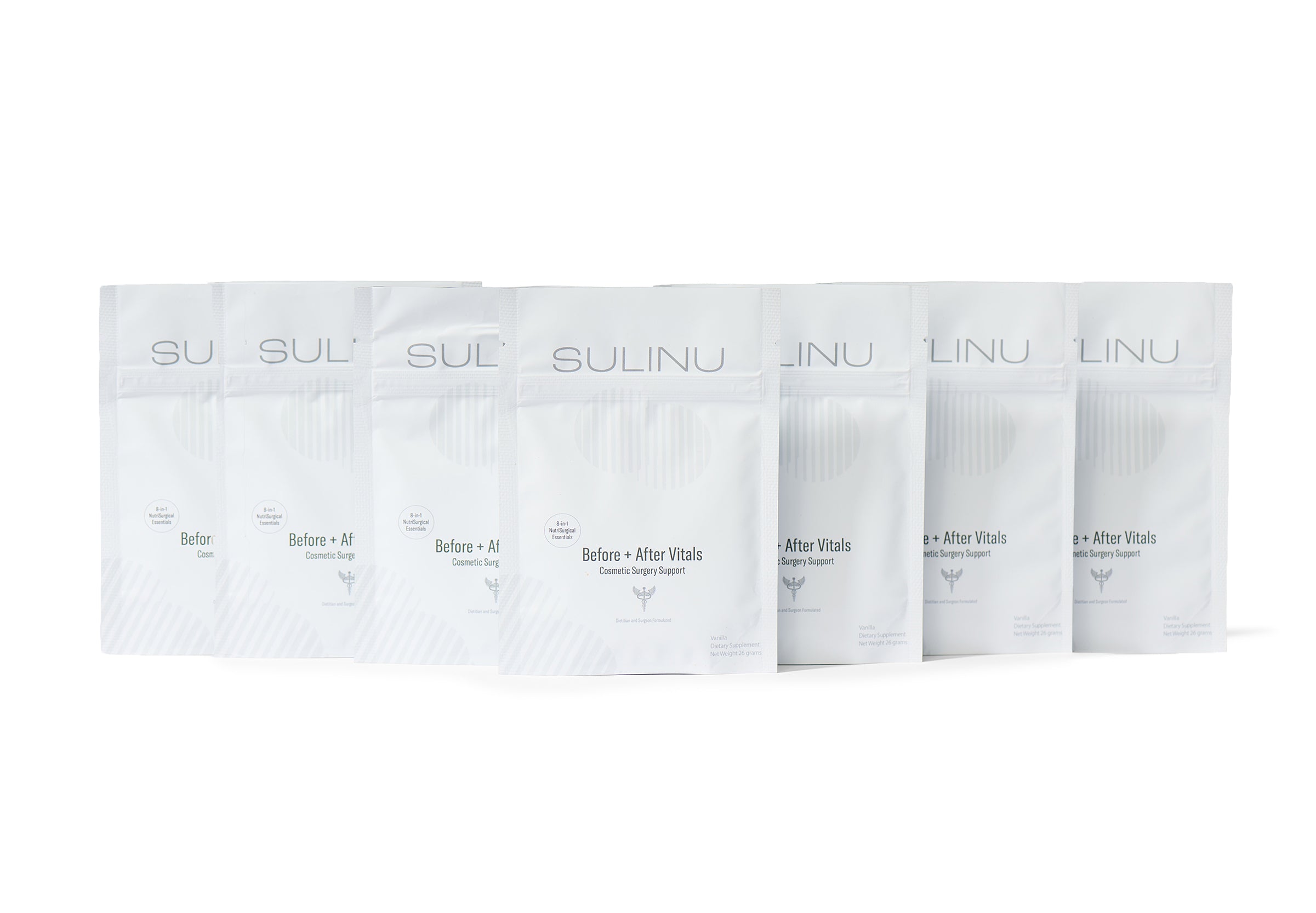 Seven white pouches of The VIP Surgical Recovery Kit are arranged in a slight arc. The labels on the bags read Before + After Vitals Dietary Supplement, an essential part of any surgical recovery kit designed to support cosmetic surgery recovery. The background is plain white.
